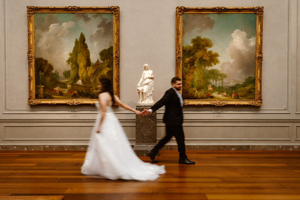 the wedding couple taking create elopement photos at the art museum
