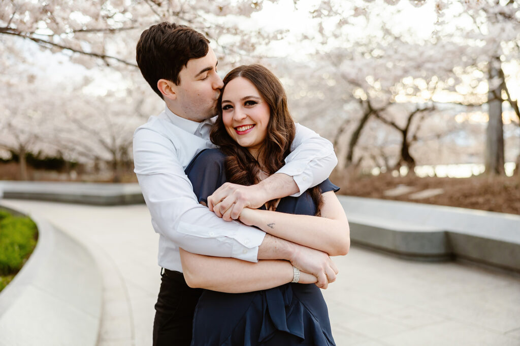 the engaged couple by the cherry blossoms in DC