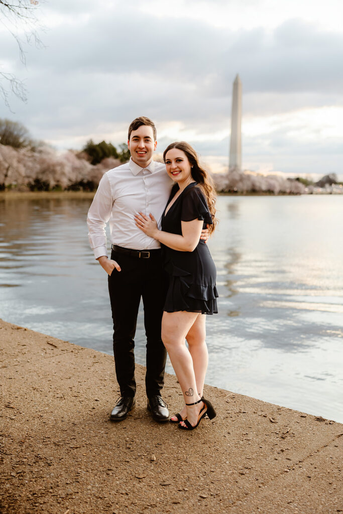 the engaged couple at the Reflection Pool for spring engagement photos