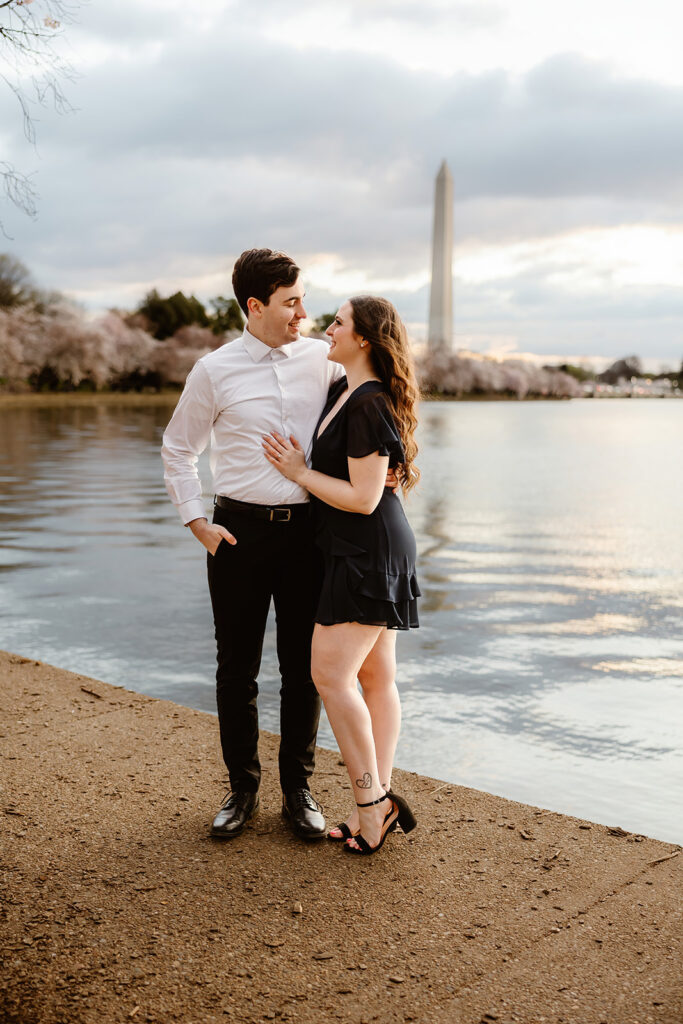 the engaged couple at the Reflection Pool for engagement photos