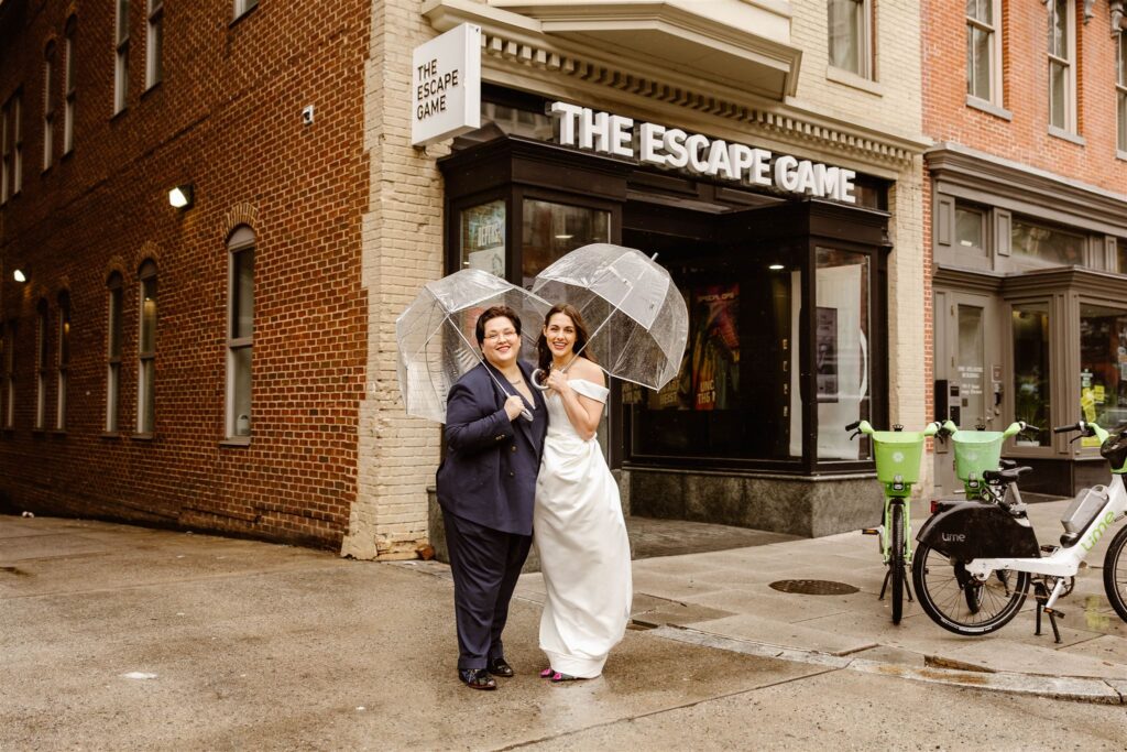lgbtq elopement couple in front of an escape room