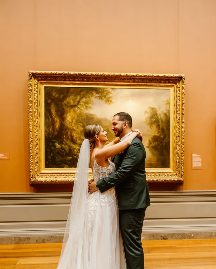 sweet elopement couple in front of a painting during their elopement at the national gallery of art in dc