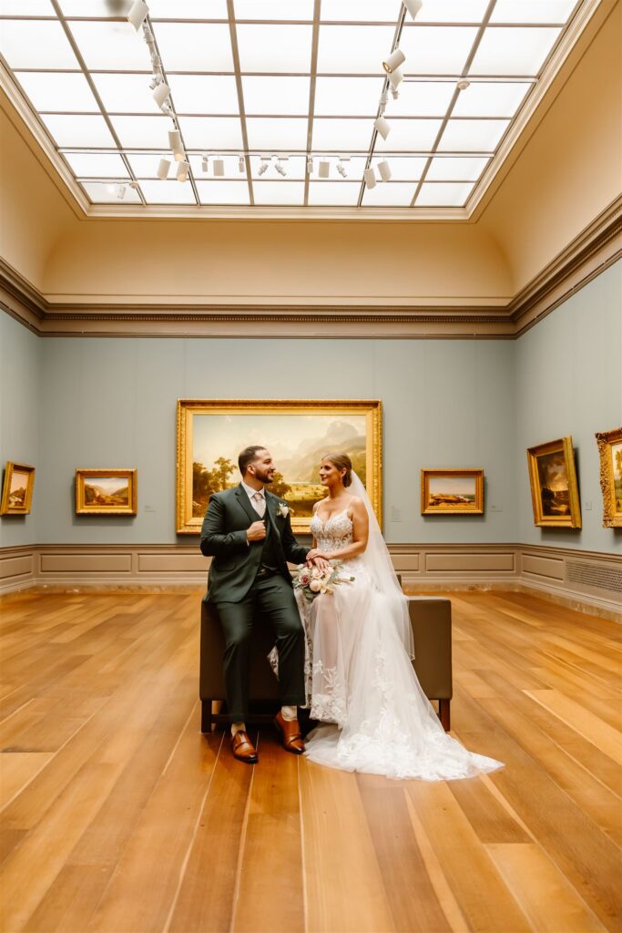 sweet elopement couple in front of a painting during their elopement at the national gallery of art in dc