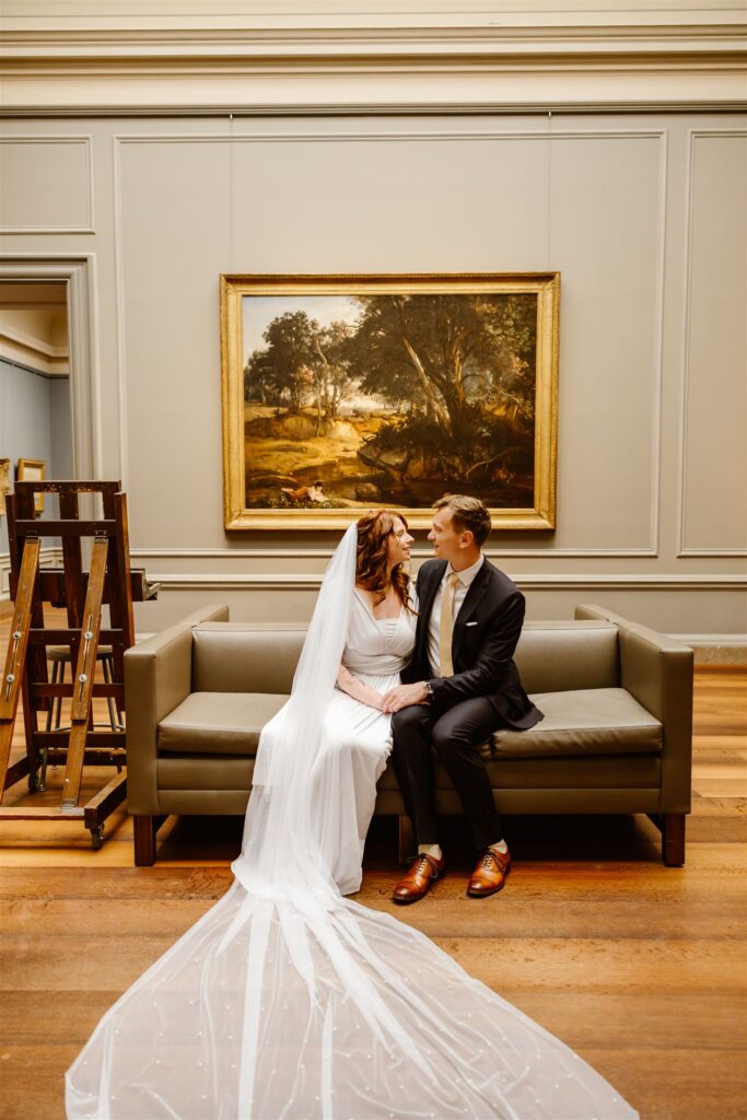 sweet elopement couple in front of a painting during their elopement at the national gallery of art in dc