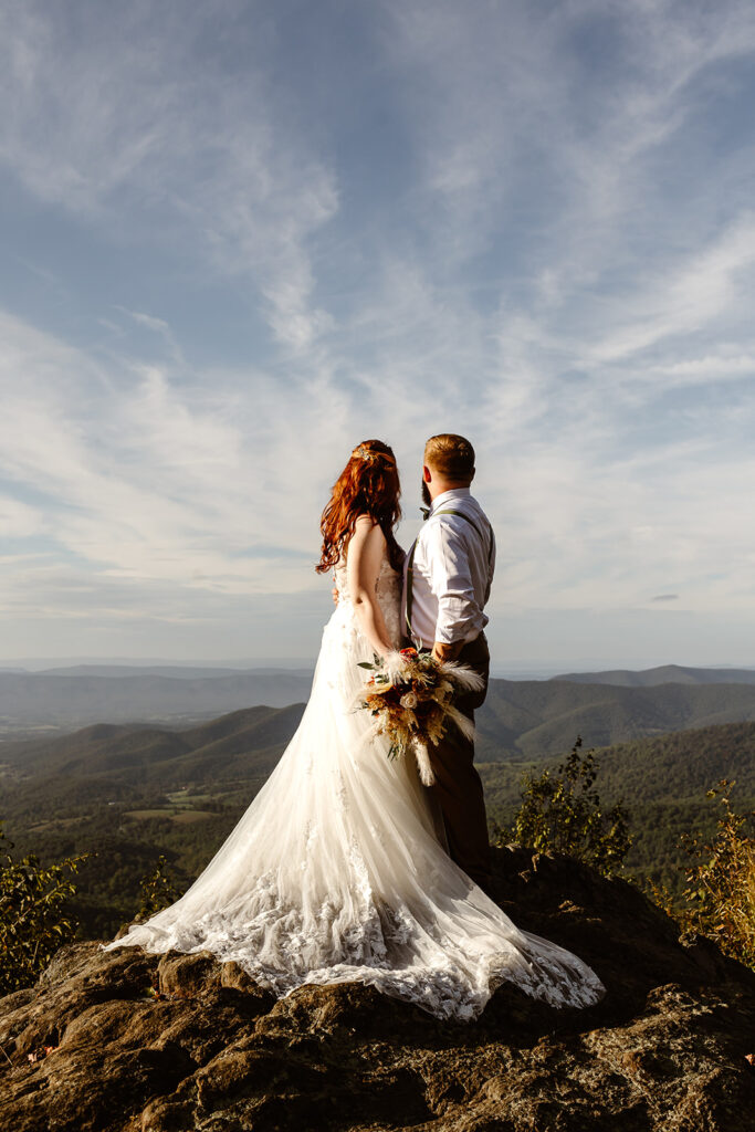 the wedding couple on top of the Blue Ridge Mountains facing the sky