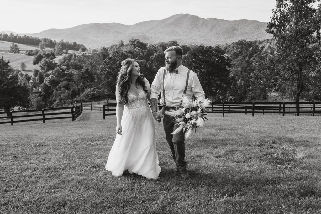 the wedding couple walking along the property at the VRBO by Shenandoah National Park