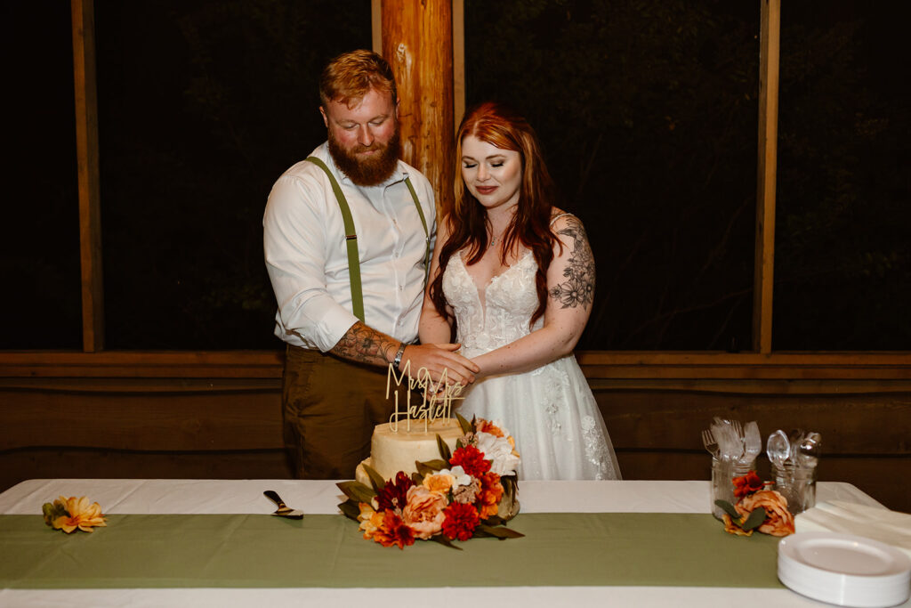 the wedding couple cutting the cake at their wedding in Virginia