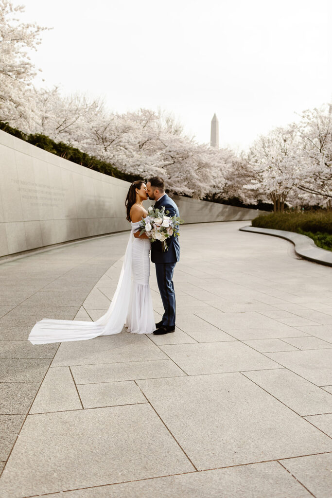 the wedding couple with the cherry blossoms in DC