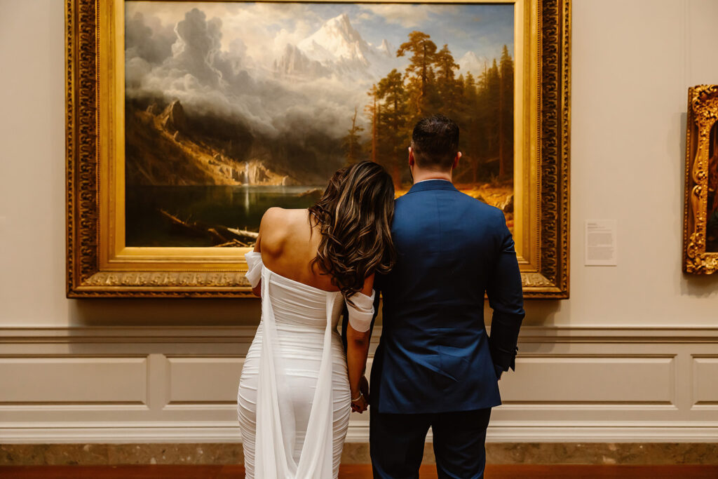 the wedding couple laying her head on the shoulder of the groom at the National Gallery of Art