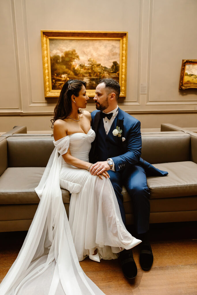 the wedding couple at the National Gallery of Art sitting on a couch