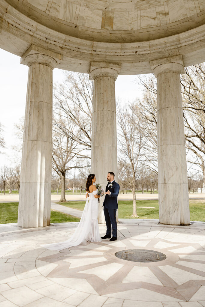 the wedding couple standing at the DC War Memorial for their elopement ceremony