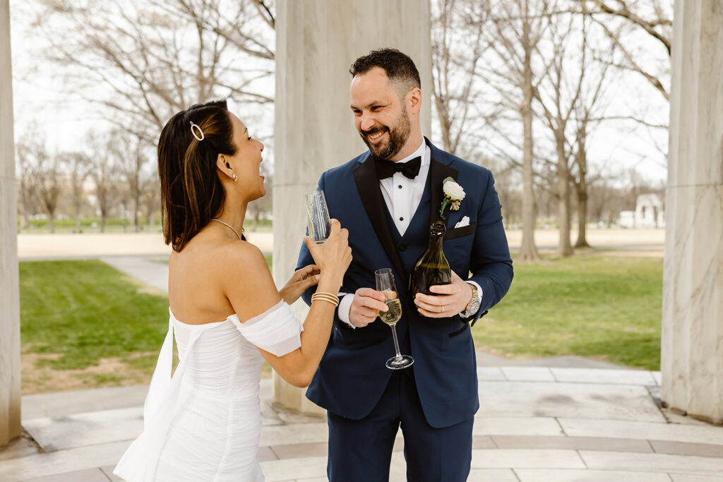 the wedding couple celebrating with champagne at the DC War Memorial