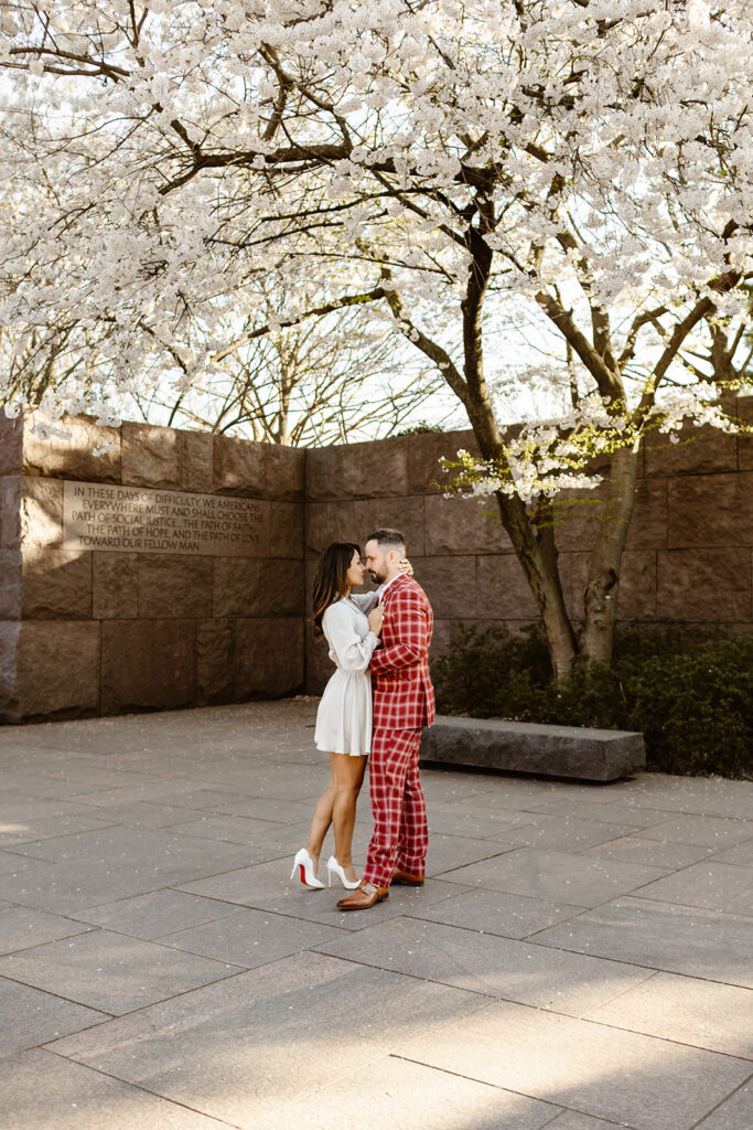 the wedding couple by the white cherry blossoms in DC