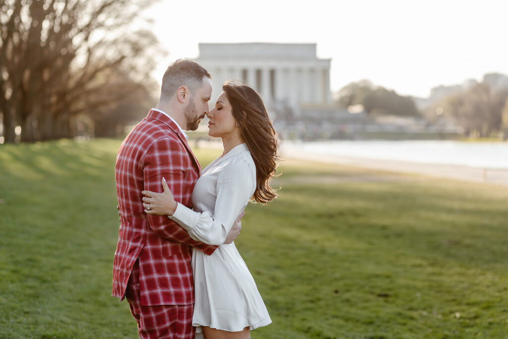 the engaged couple at the Lincoln Memorial during golden hour