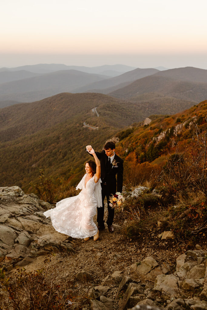 the elopement couple dancing on top of the mountain 