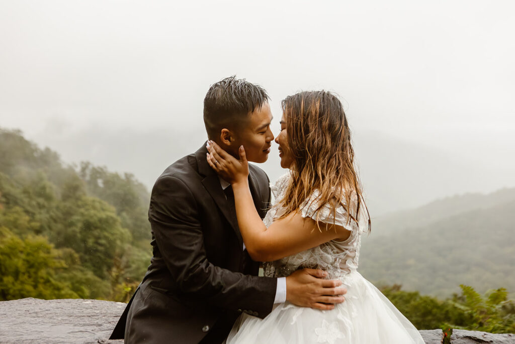 the wedding couple leaning in to kiss in the rain during their Shenandoah Park elopement