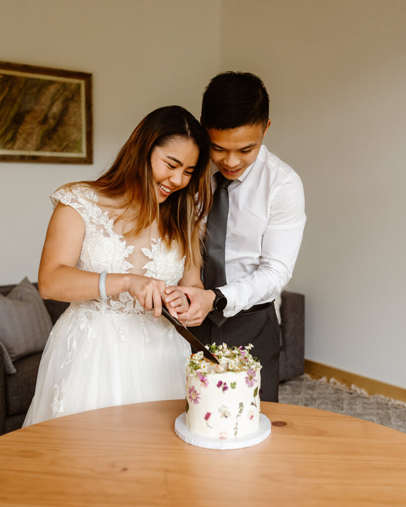 the wedding couple cutting their wedding cake