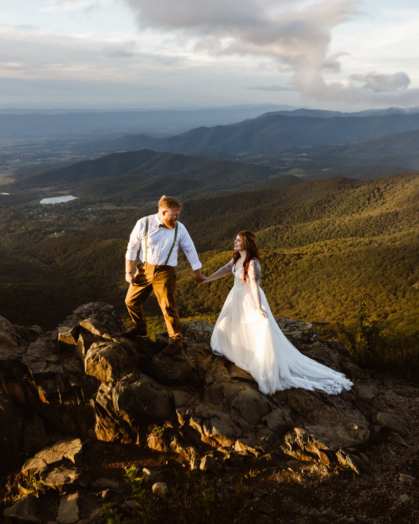 the elopement couple hiking the mountain for their adventure elopement 