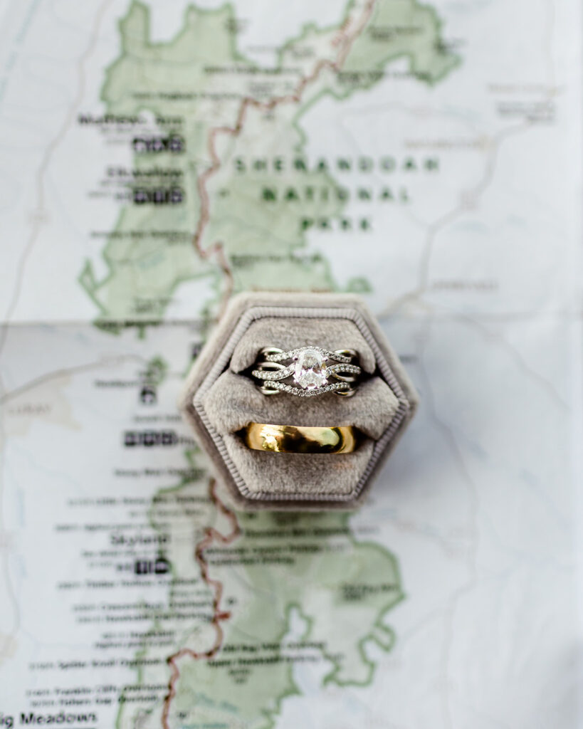 the wedding rings of the adventure elopement on top of a map of Shenandoah National Park