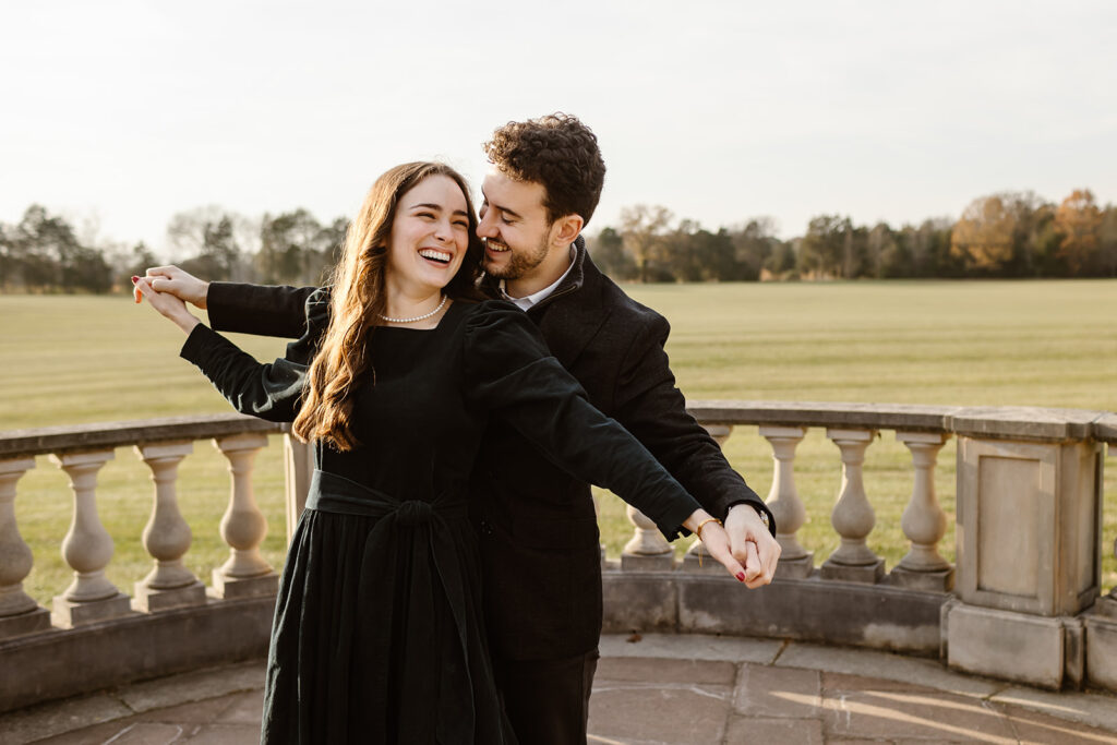 the engaged couple doing the airplane pose for their proposal photos