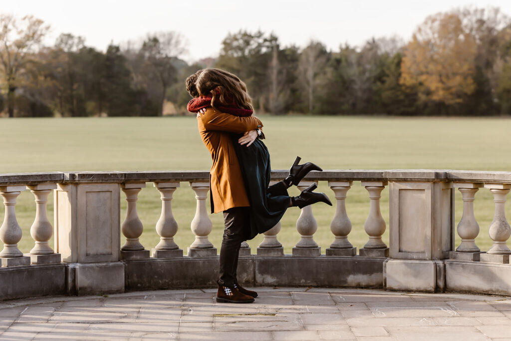 the engaged couple hugging each other after the surprise proposal