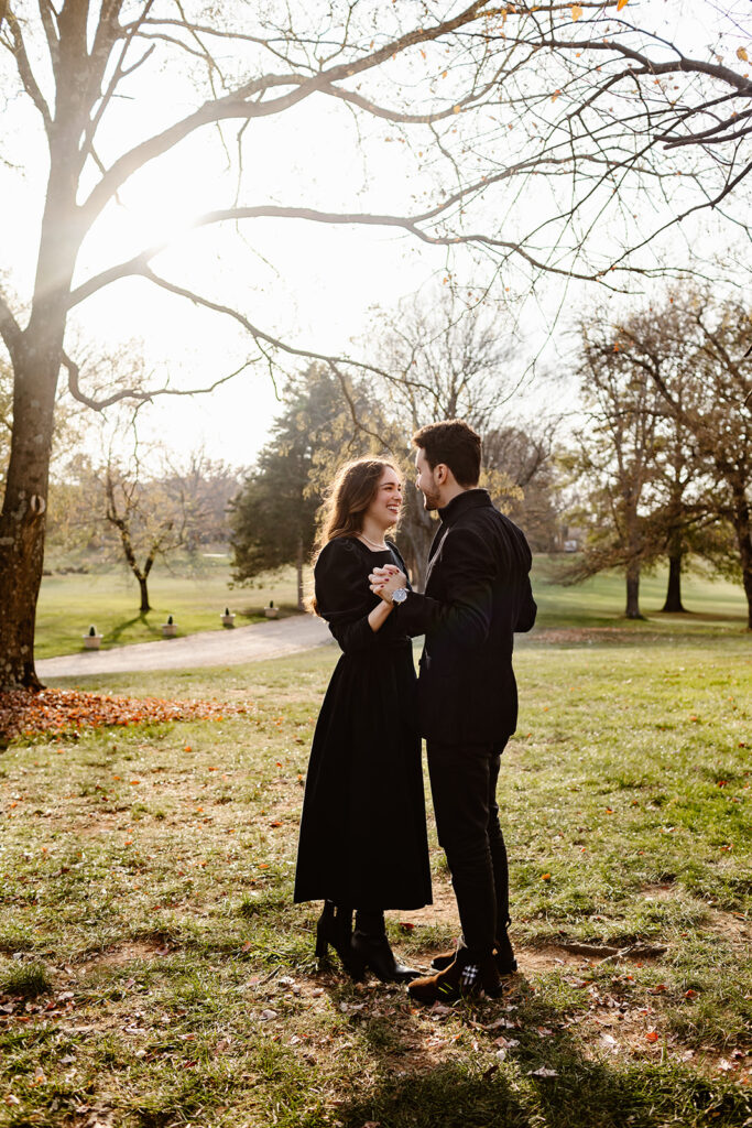 the engaged couple taking golden hour engagement photos at the Great Marsh Estate