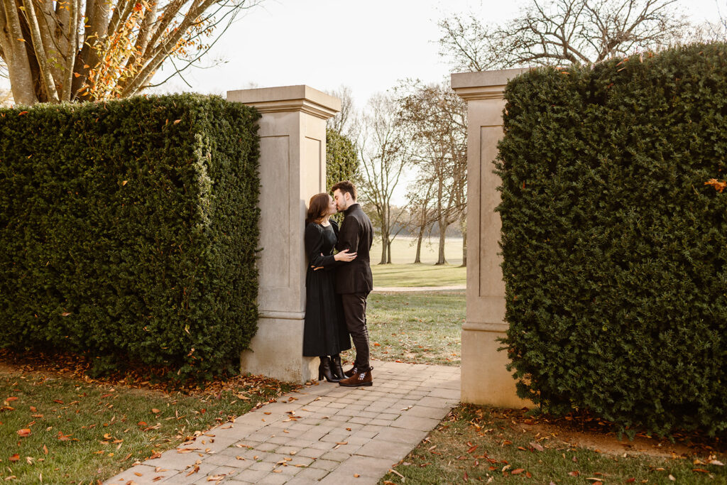 the engaged couple kissing in the garden 