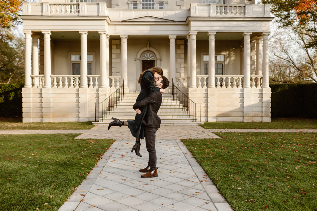 the engaged couple being lifted for a romantic kiss in Virginia