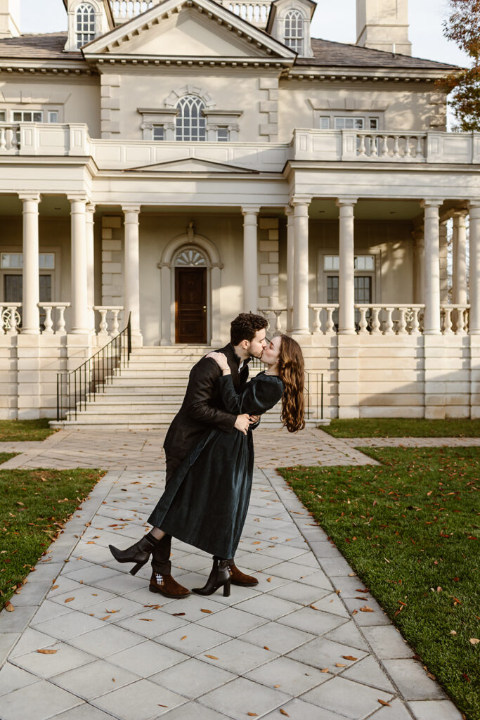 the engaged couple kissing after their surprise proposal with a dip kiss