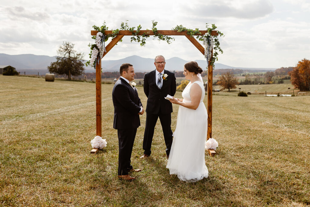 the wedding couple saying their vows at their fall elopement