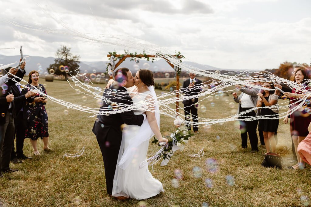 the wedding couple after their wedding ceremony with streamers 