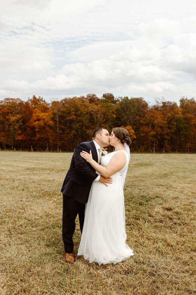 the wedding couple kissing during their fall elopement