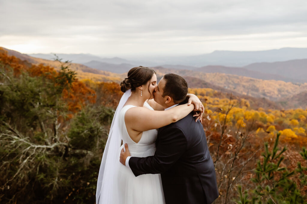 the wedding couple kissing on the mountains at Shenandoah