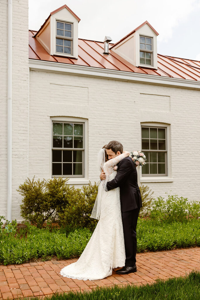 the wedding couple hugging each other after their first look