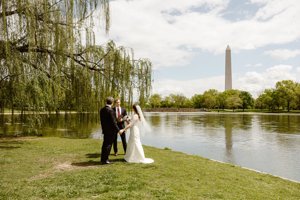 the wedding couple saying their vows by the Washington Monument