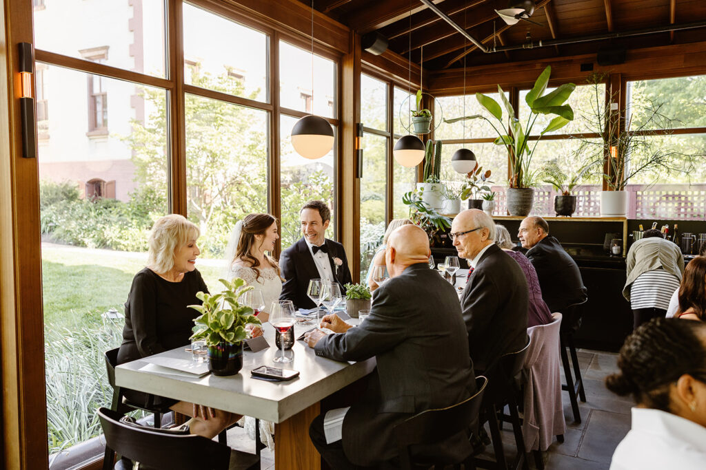 the wedding couple eating with their guests at their reception