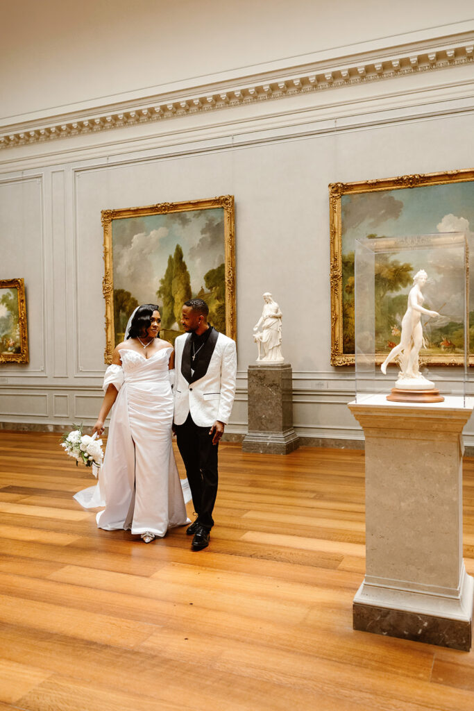 the wedding couple walking through the National Gallery of Art