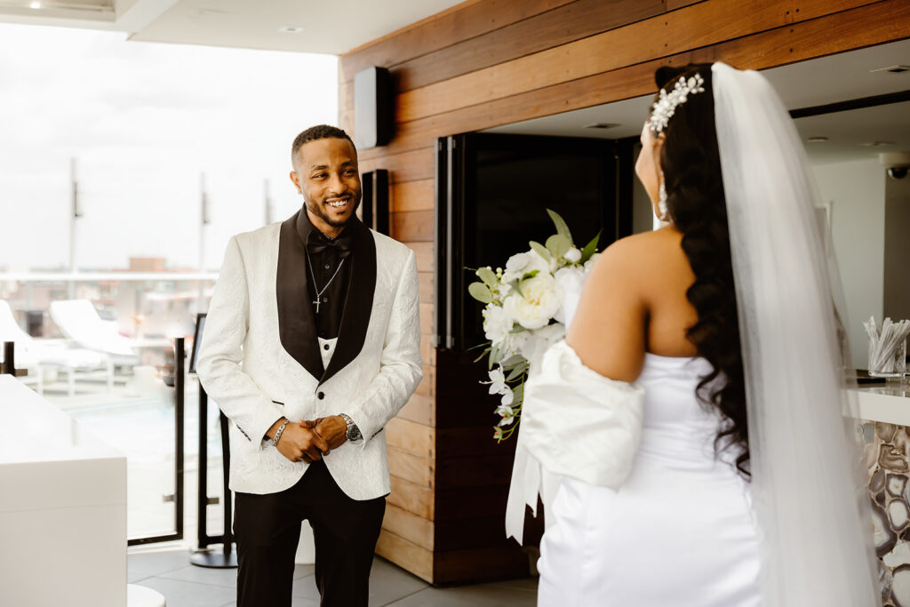 the wedding couple at their first look on the rooftop