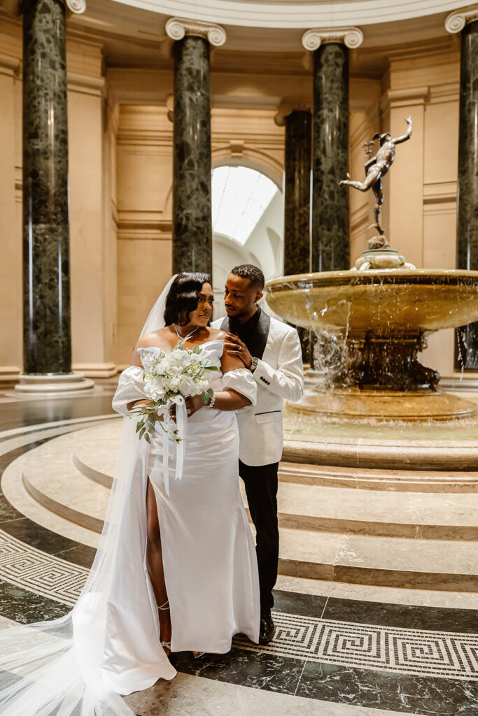 the wedding couple posing in the National Gallery of Art