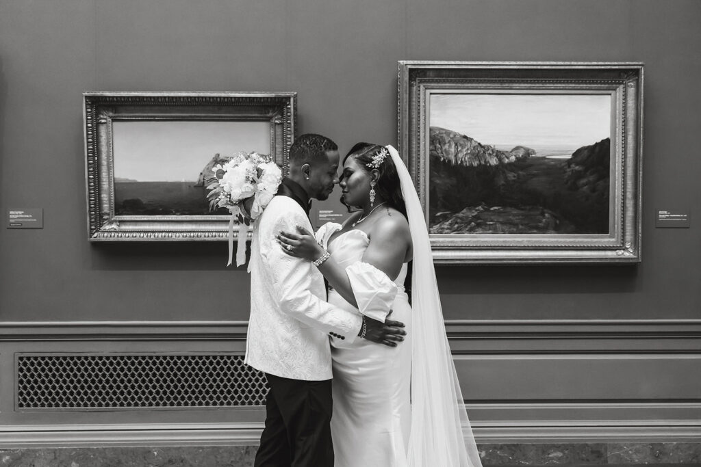 the wedding couple posing by the art at the National Gallery of Art