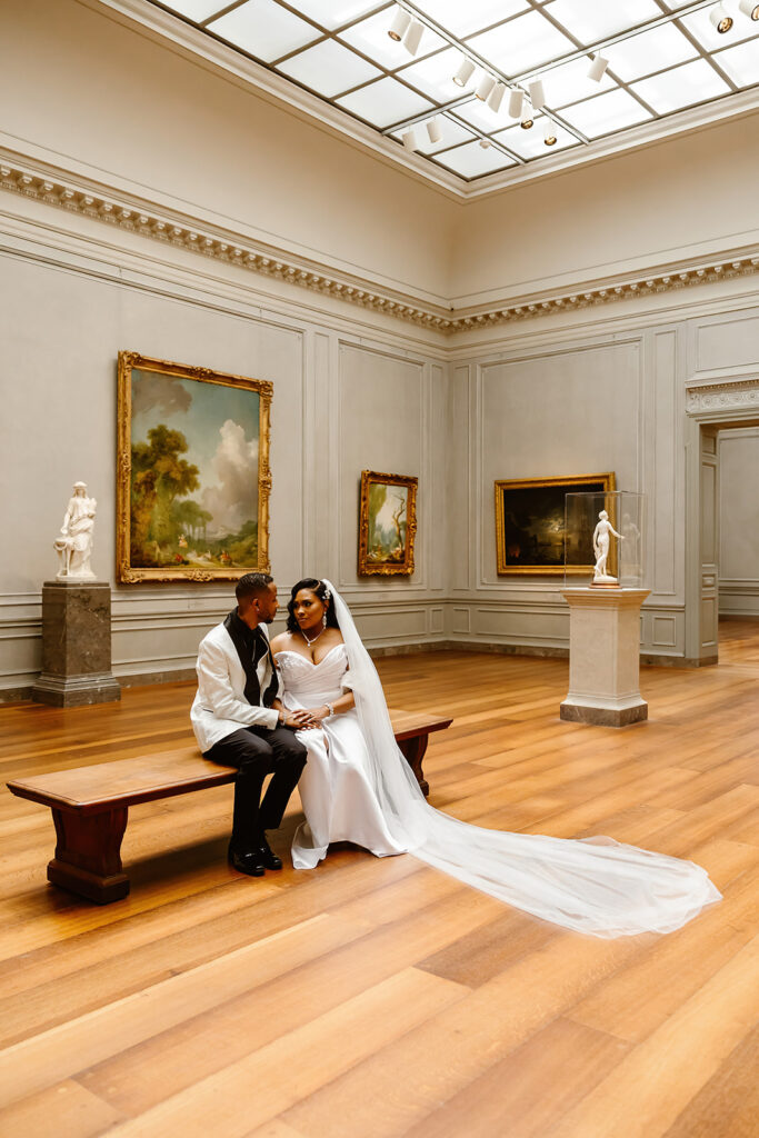 the wedding couple sitting on the benches at the National Gallery of Art