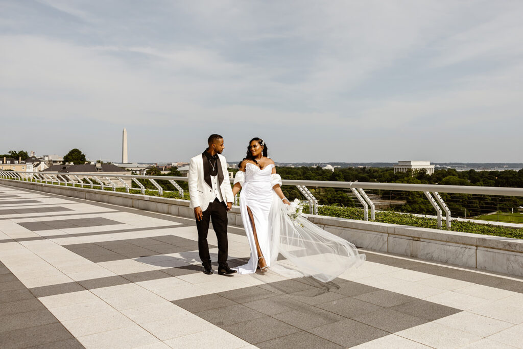 the wedding couple walking on the rooftop at the Kennedy Center