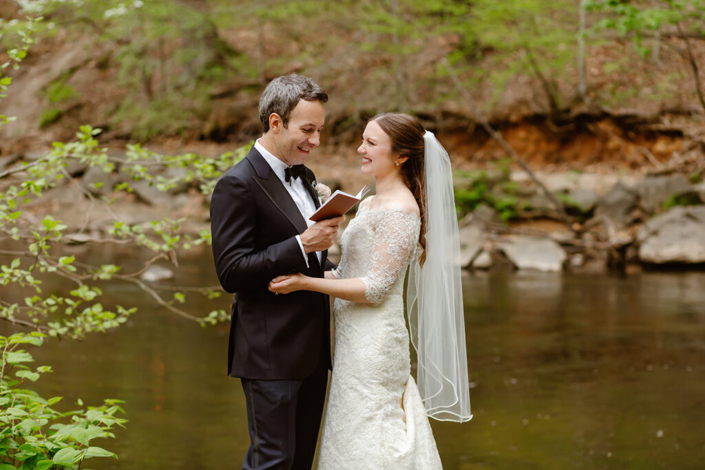 Bride and groom exchanging vows by water