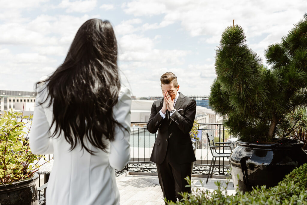 the groom seeing the bride during their first look on the rooftop of the hotel in DC