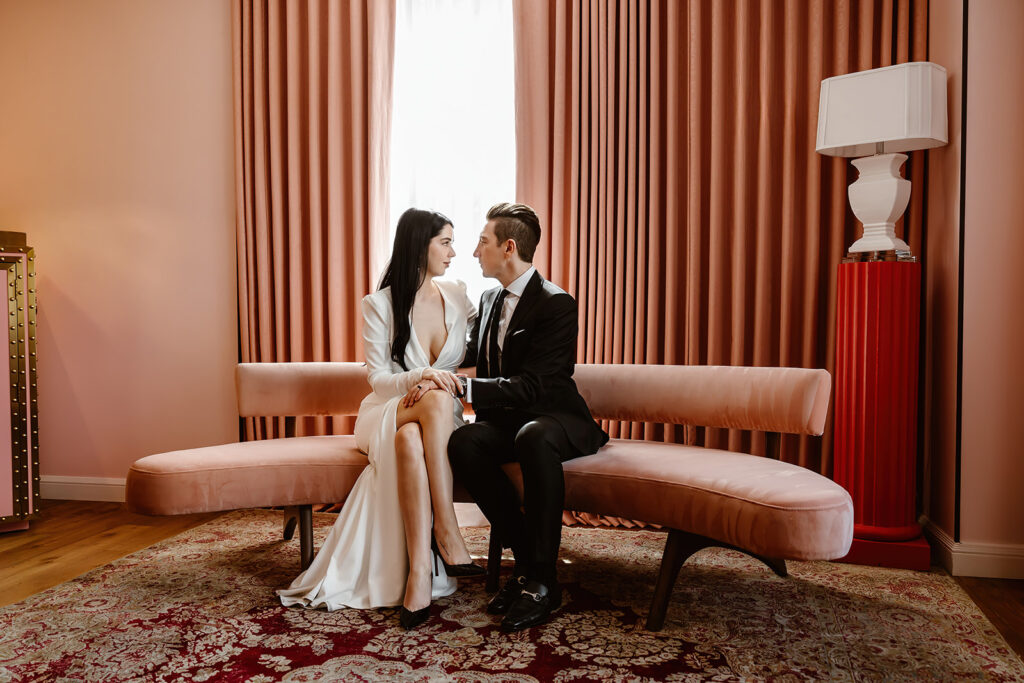 the wedding couple sitting in the pink room at the hotel in Washington DC