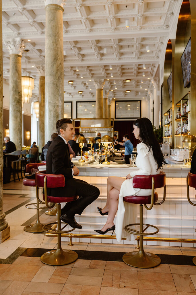 the wedding couple grabbing drinks together at their Washington DC hotel