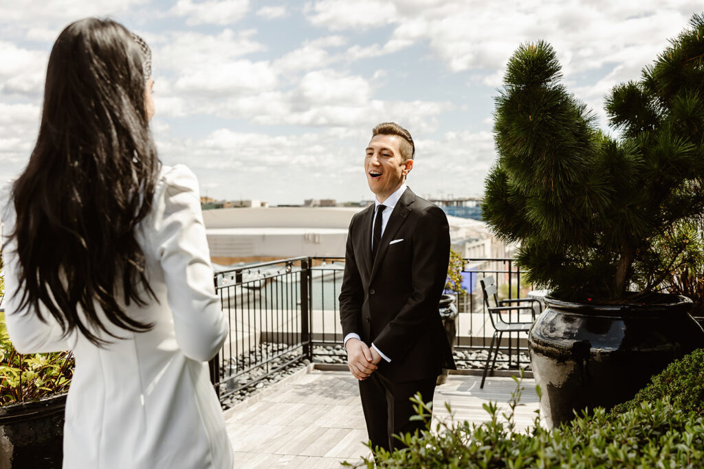 the bride and groom on the rooftop for first look photos