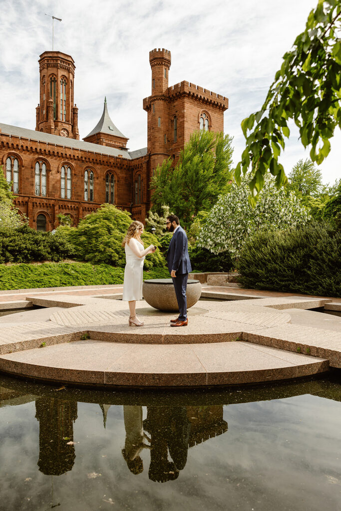 the wedding couple sharing their wedding vows at the Smithsonian Castle