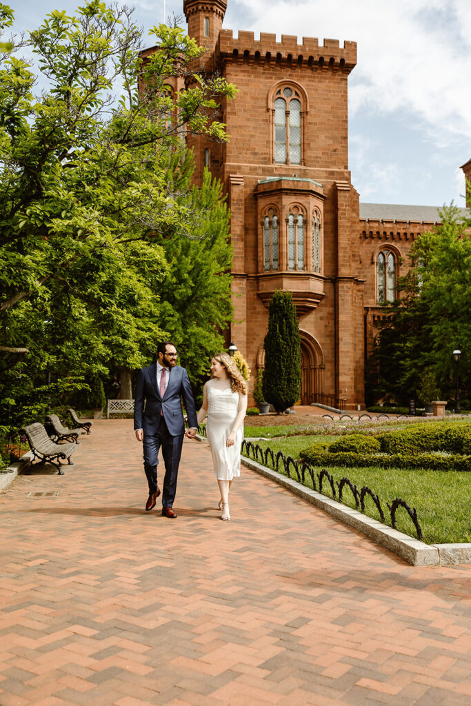 the wedding couple holding hands and walking together during their DC elopement