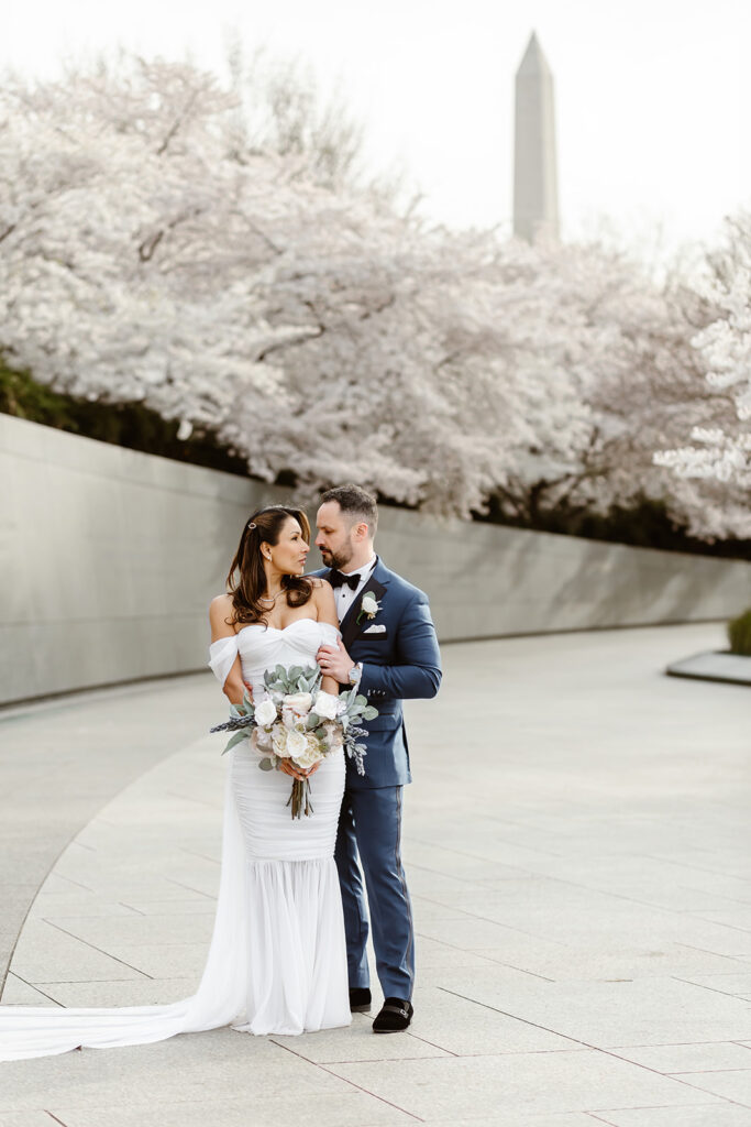 bride and groom surrounded by cherry blossoms during their dc elopement